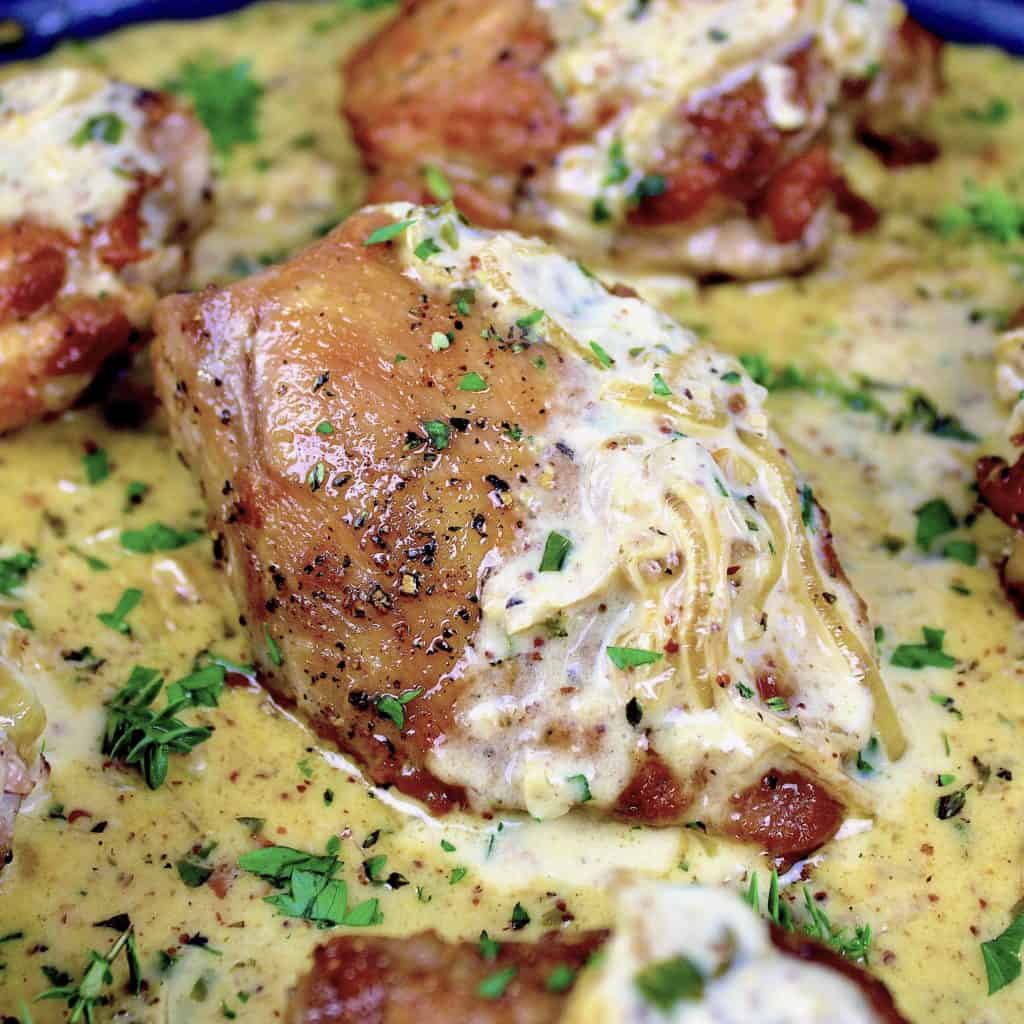 closeup of chicken dijon thigh in sauce