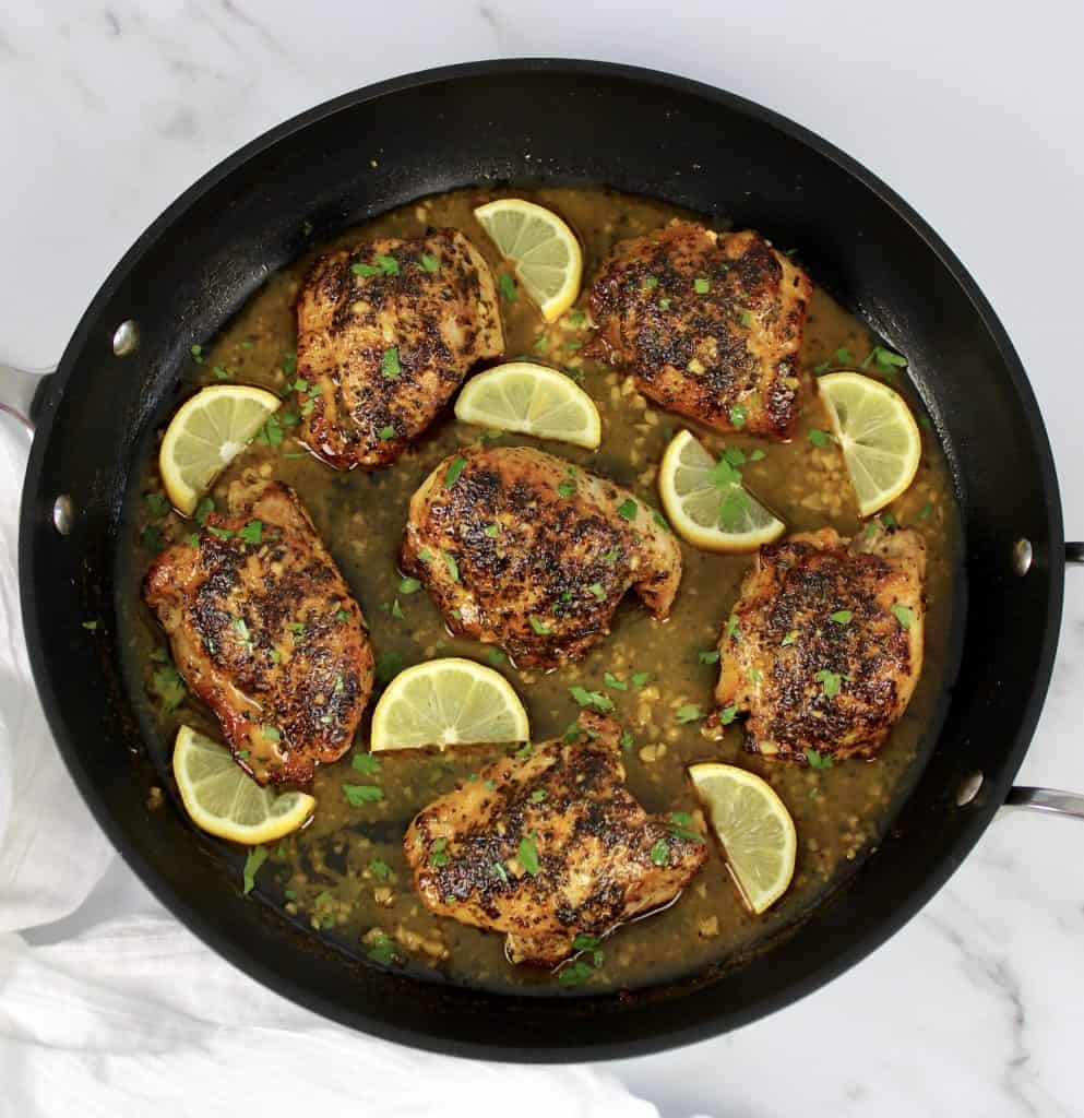 Lemon Chicken with lemon slices in lemon sauce in skillet
