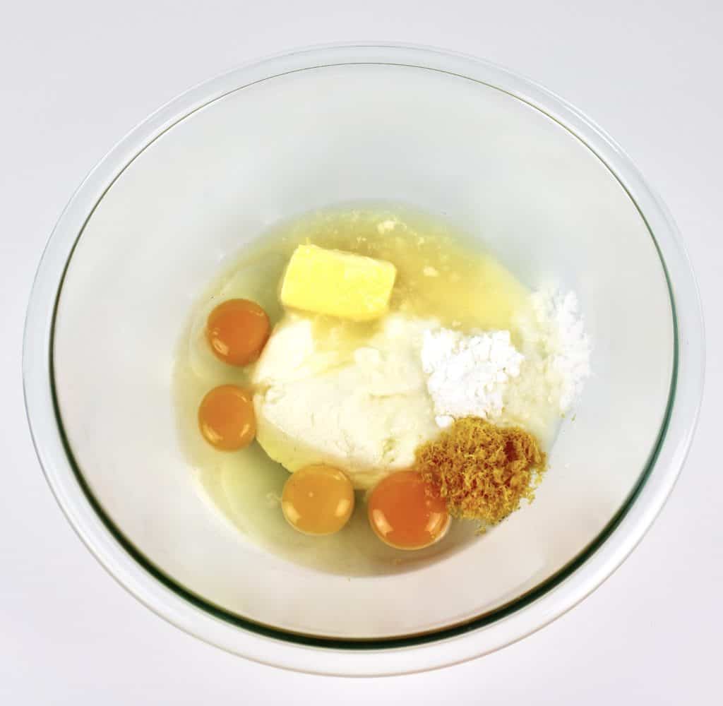 wet ingredients for lemon ricotta cake in glass bowl unmixed