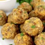 sausage balls on white plate with honey mustard on side