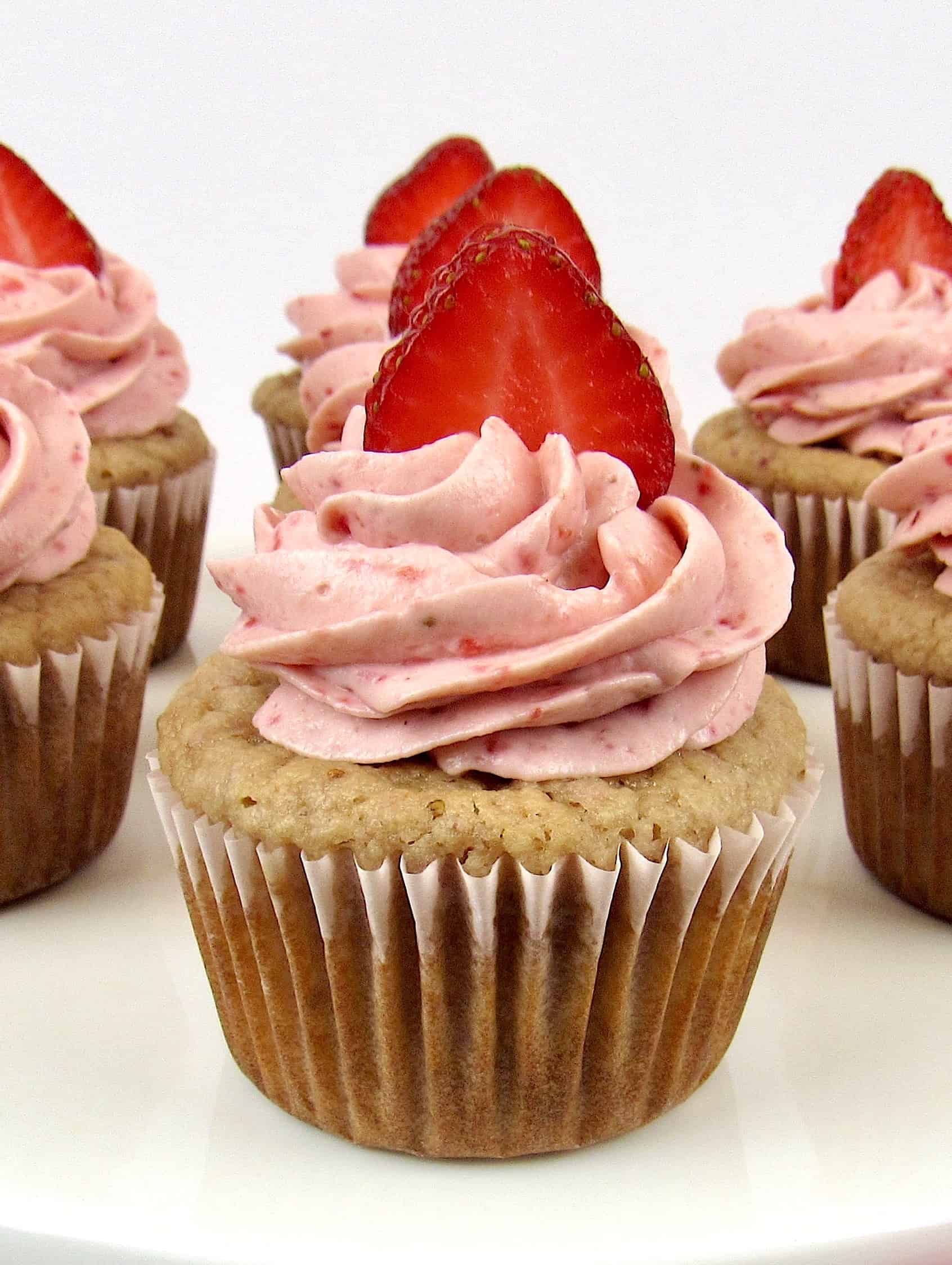 closeup of strawberry cupcake with sliced strawberry on top