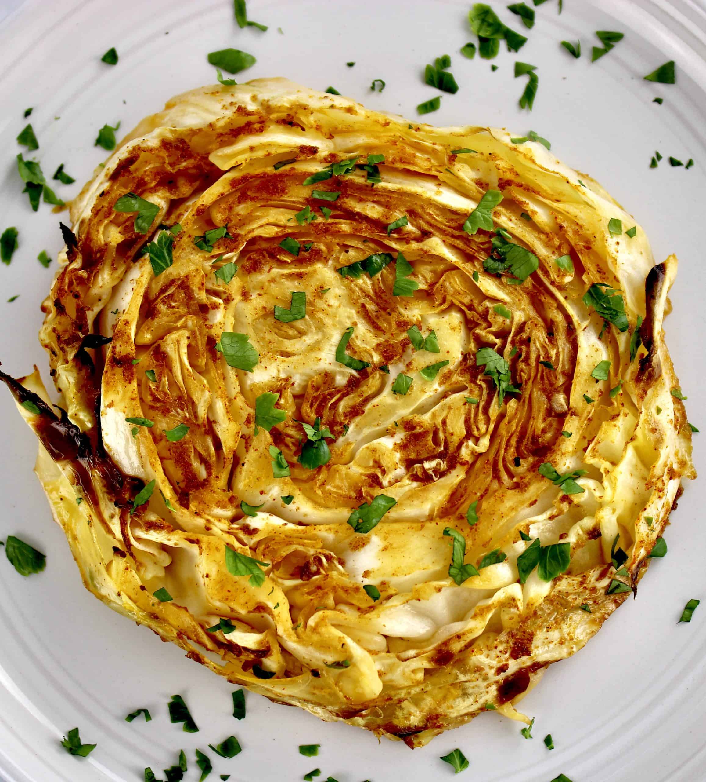 closeup of Roasted Cabbage Steak on white plate