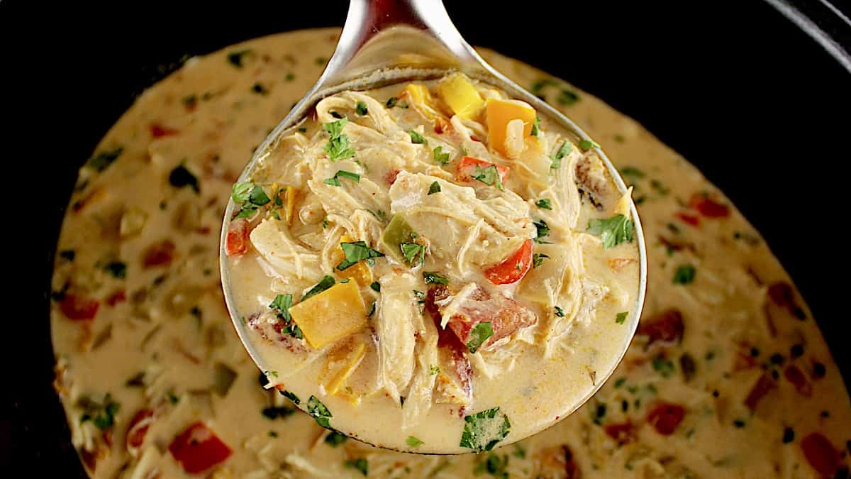 closeup of Slow Cooker Chicken Fajita Soup in silver ladle